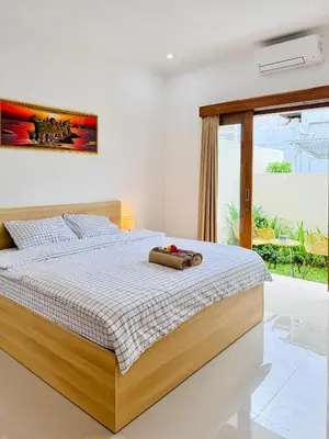 a bedroom with a bed in a room with a window at Y&J in Seminyak