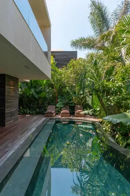 a swimming pool in the middle of a house at Villa Fiji by Villa Finder in Canggu