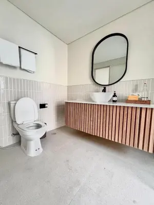 a bathroom with a toilet and a sink and a mirror at Sofira Villa 2 bedroom in Nusa Dua