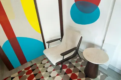 a chair and a table in front of a wall at 3BR Villa Kita - Minggu Villas-Special Stay Bonus in Seminyak