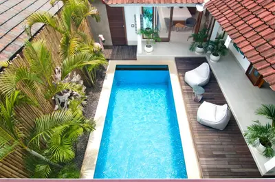 an overhead view of a swimming pool with palm trees at 3BR Villa Kita - Minggu Villas-Special Stay Bonus in Seminyak