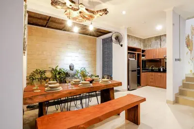 a kitchen with a wooden table and a dining room at Villa Narada - Convenient Location - Private Pool - 3BR Villa in Seminyak