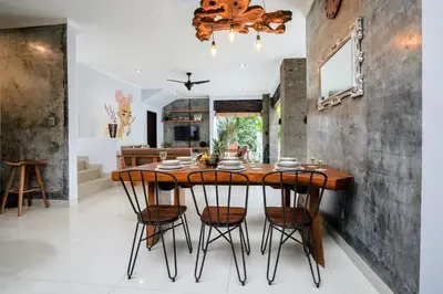 a dining room with a wooden table and chairs at Villa Narada - Convenient Location - Private Pool - 3BR Villa in Seminyak