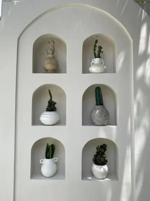 a white shelf with nine vases with cactus in them at Villa EL NIS - LEGIAN - 4 Bedroom - 4 Bathroom - Luxury in Legian