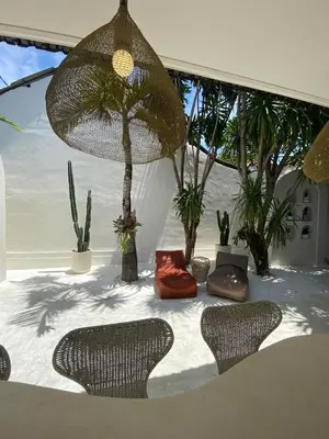 a patio with two chairs and a table and some plants at Villa EL NIS - LEGIAN - 4 Bedroom - 4 Bathroom - Luxury in Legian