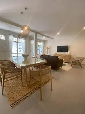 a living room with a table and a couch at Villa EL NIS - LEGIAN - 4 Bedroom - 4 Bathroom - Luxury in Legian