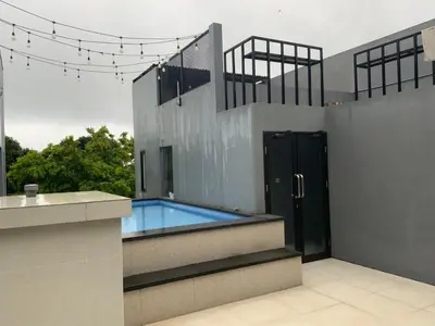 a house with a swimming pool on the side of it at Bali queen elephant boutique villa in Jimbaran