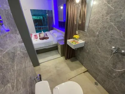 a bathroom with a bed and a toilet and a shower at Bali queen elephant boutique villa in Jimbaran