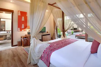 a bedroom with a white bed with a canopy at Cozy 2 BR Private Pool Villa in Seminyak