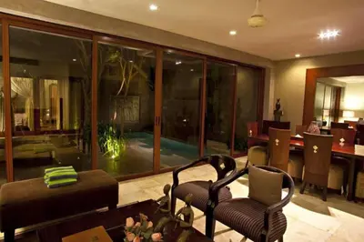 a living room with a couch and chairs and a table at Cozy 2 BR Private Pool Villa in Seminyak