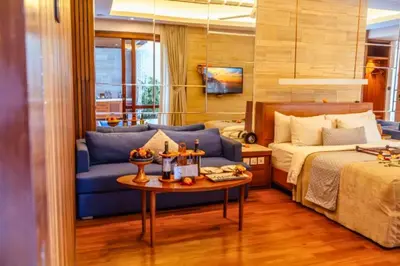 a bedroom with a blue couch and a bed at Smart 1 BR Villa with Private Pool in Seminyak