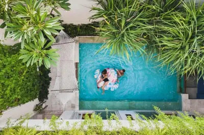 a person in a surfboard in a swimming pool at Smart 1 BR Villa with Private Pool in Seminyak