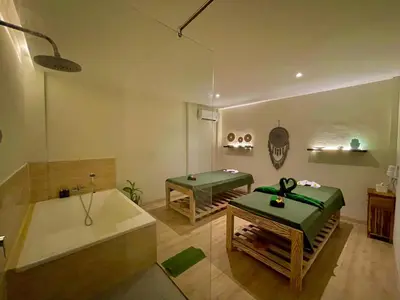 a bathroom with a tub and a sink and a bath tub at Abian Klumpu Villa & Spa Sanur Bali in Sanur