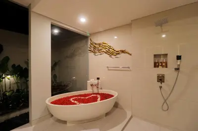 a bathroom with a bath tub filled with red substance at Sudha Villa Bali A in Seminyak