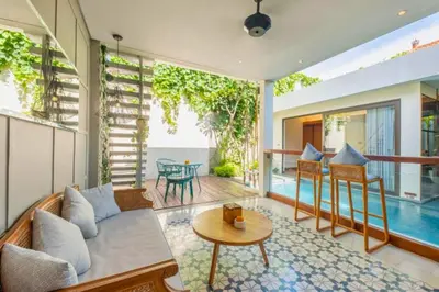 a living room with a couch and a table at Modern 1 BR Villa with Private Pool in Seminyak