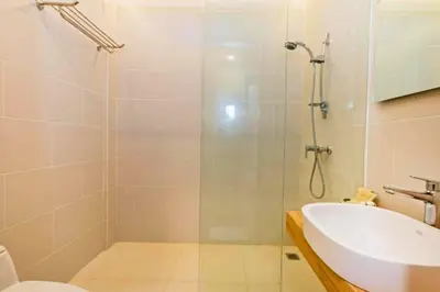 a bathroom with a shower and a toilet and a sink at Luxury 1 BR Deluxe Twin Room in Canggu