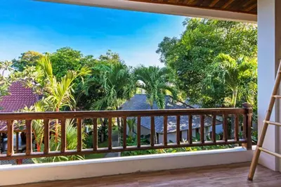 a room with a balcony with a view of the ocean at Beautiful 1BR Deluxe Double Room in Canggu