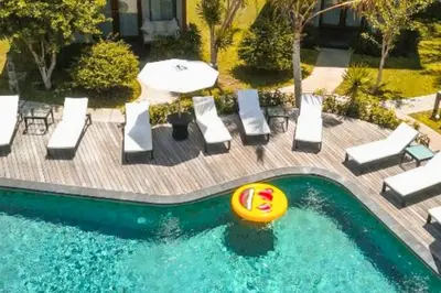 a pool with chairs and a frisbee in it at Beautiful 1BR Deluxe Double Room in Canggu