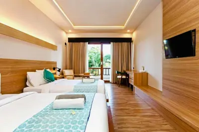 a hotel room with two beds and a television at Beautiful 1BR Deluxe Double Room in Canggu