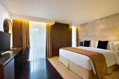 a hotel room with a large bed and a television at Antariksha 1 BR Superior Room in Seminyak