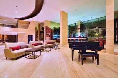 a living room with a piano and couches at Damarlangit 1 BR Superior Terrace in Seminyak