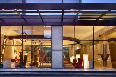 a large building with glass windows and furniture in it at Viorel 1 BR Whirlpool Suite Room in Seminyak