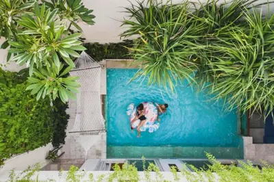 a painting of a dog swimming in a pool at Luxury 2 BR Villa with Private Pool & Bathtub in Seminyak