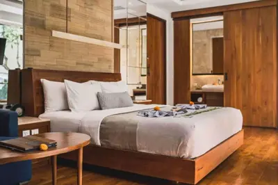 a bedroom with a bed and a table and a desk at Luxury 2 BR Villa with Private Pool & Bathtub in Seminyak