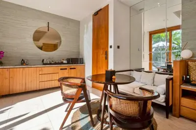 a kitchen and living room with a table and chairs at Entire 1 BR Villa With Private Pool in Seminyak