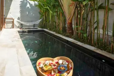 a bowl of food sitting on a table next to a pool at Entire 1 BR Villa With Private Pool in Seminyak
