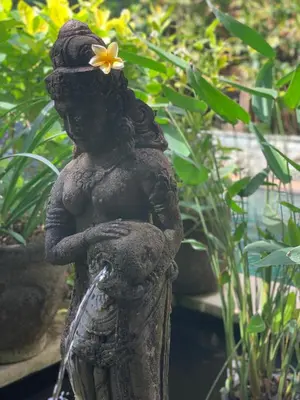 a statue of a woman with a flower on her head at Villa Petra Seminyak Bali in Seminyak