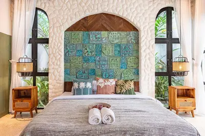 a bedroom with a bed with two slippers on it at Casa Toledo 1 Bedroom Seminyak - Kerobokan in Seminyak