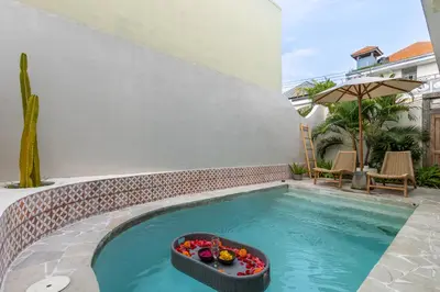 a swimming pool with a bowl of fruit in the middle at Casa Toledo 1 Bedroom Seminyak - Kerobokan in Seminyak