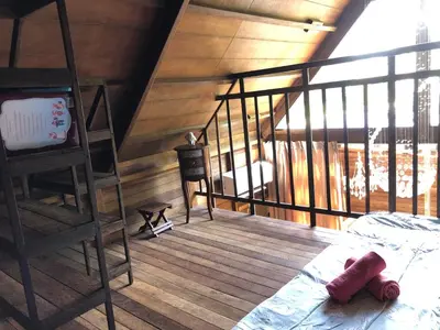 a room with a ladder and a bed in a room at Villa Divna in Nusa Dua