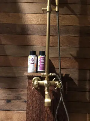 two medicine bottles are sitting on a bathroom faucet at Villa Divna in Nusa Dua