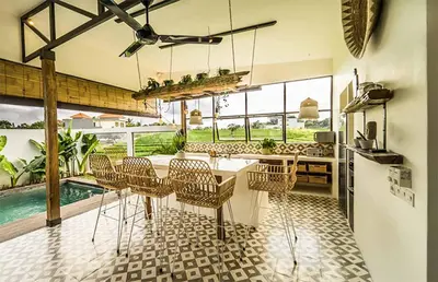 a kitchen and dining room with a table and chairs at Villa Kosibali by Optimum Bali Villas in Kerobokan