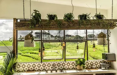 a room with a window with potted plants on it at Villa Kosibali by Optimum Bali Villas in Kerobokan