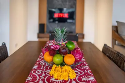 a table with a bowl of fruit on top of it at Villa MD 2 Stylish 3 BR w/ Sunny Pool at Prime Eat Street in Seminyak