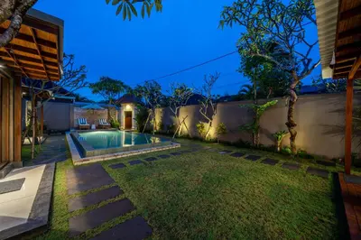 a backyard with a swimming pool and a fence at Villa MD 2 Stylish 3 BR w/ Sunny Pool at Prime Eat Street in Seminyak