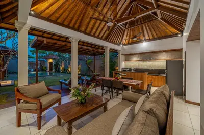 a living room with a couch and a table at Villa MD 2 Stylish 3 BR w/ Sunny Pool at Prime Eat Street in Seminyak