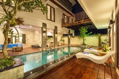 a swimming pool in the middle of a house at Villa Club Corner Residence by Nagisa Bali in Canggu