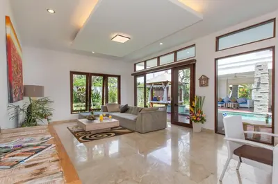 a living room with a couch and a table at Villa Club Corner Residence by Nagisa Bali in Canggu
