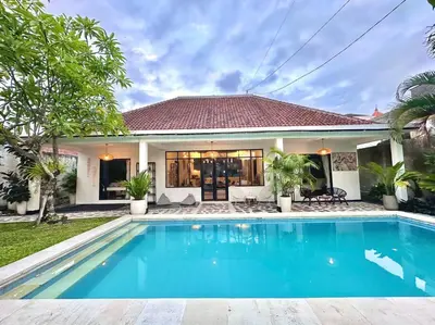 a villa with a swimming pool in front of a house at 2 BR Villa Rhapsody - 5 Mins to Seminyak/Umalas in Seminyak