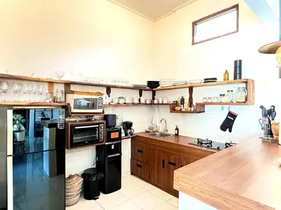 a kitchen with a black refrigerator and a counter at 2 BR Villa Rhapsody - 5 Mins to Seminyak/Umalas in Seminyak