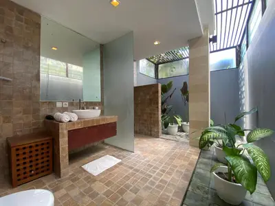 a bathroom with two sinks and a large mirror at Spacious Villa in Petitenget Top Location in Seminyak