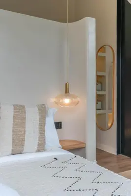 a bedroom with a bed and a mirror at Villa Maverick - Brand New Classy 4BR Villa in Canggu in Canggu