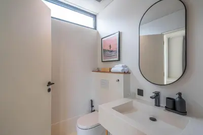 a bathroom with a sink and a mirror at Villa Maverick - Brand New Classy 4BR Villa in Canggu in Canggu