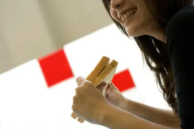 a woman holding a piece of paper in her hands at Amaris Hotel Teuku Umar in Denpasar
