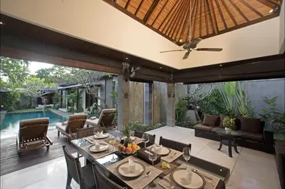 a patio with a table and chairs and a pool at Villa MD Tranquil 6BR Villa at Eat Street in Seminyak