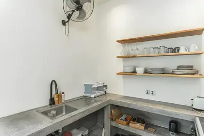 a kitchen counter with a sink and a fan at Villa GrandLux Bali 2 Bed Villa Pool Big Garden in Seminyak